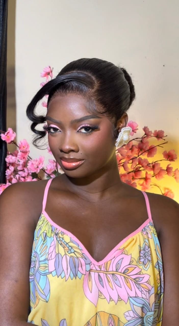 Client with sleek updo and curled wisp after wig installation at Hairxpresser.NG