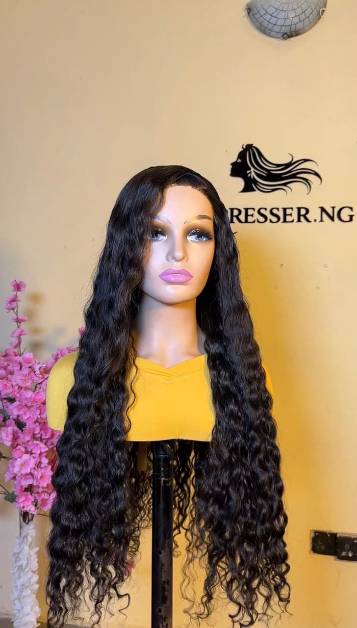 Long black deep wave lace-front wig styled at Hairxpresser.NG